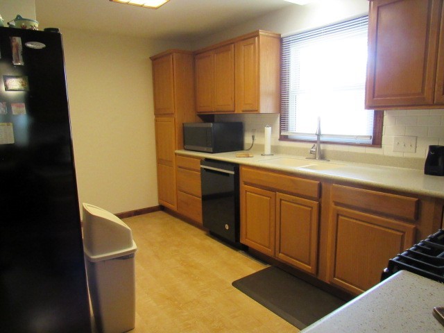 309 Cedar Drive Clinton, IL 61727 - Photo 8 of 20 a kitchen with a sink a window and cabinets