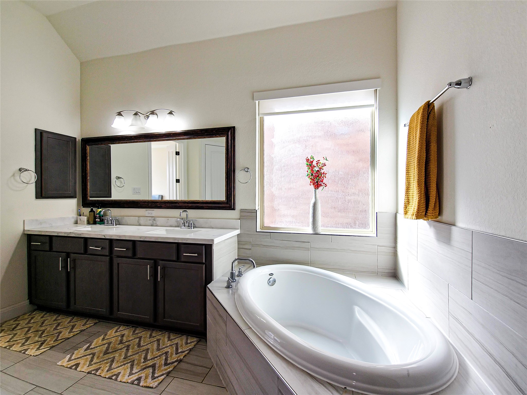 813 Sunny Ridge Drive Leander, TX 78641 - Photo 27 of 32 Relax in the deep soaking tub or enjoy the spacious dual vanity with ample counter space.