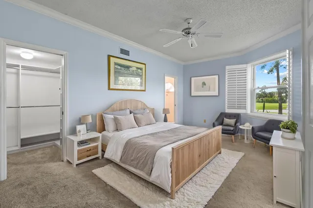 a bedroom with a bed couch and a window