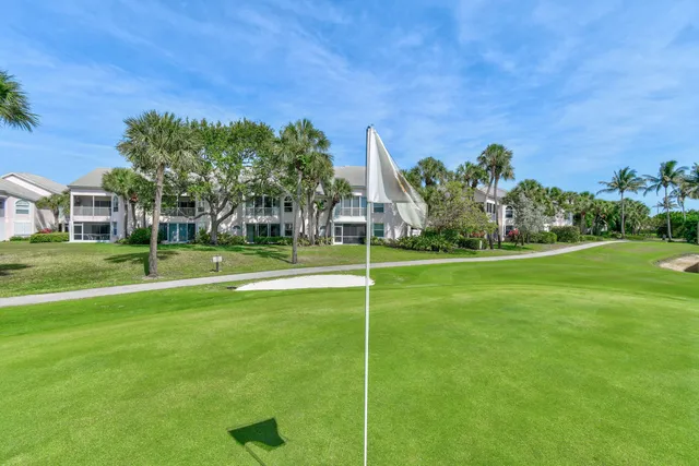 a sign that is sitting in front of flowers