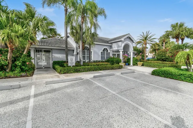 a view of a swimming pool with a patio and plants