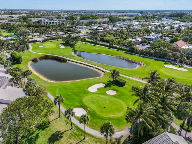 an aerial view of residential houses with outdoor space and river