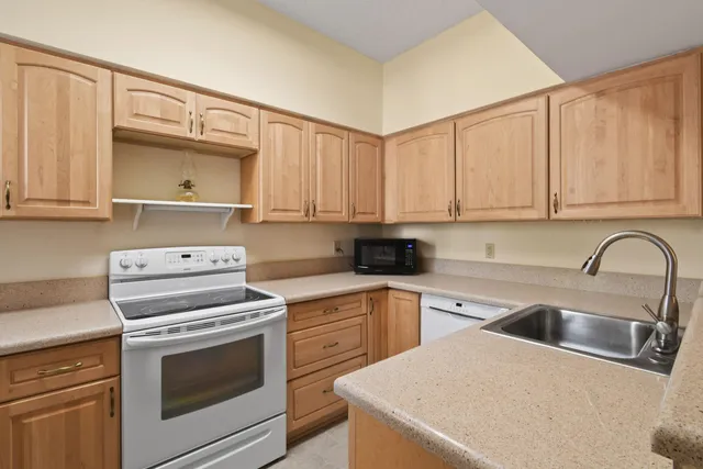 a kitchen with a sink stove and cabinets