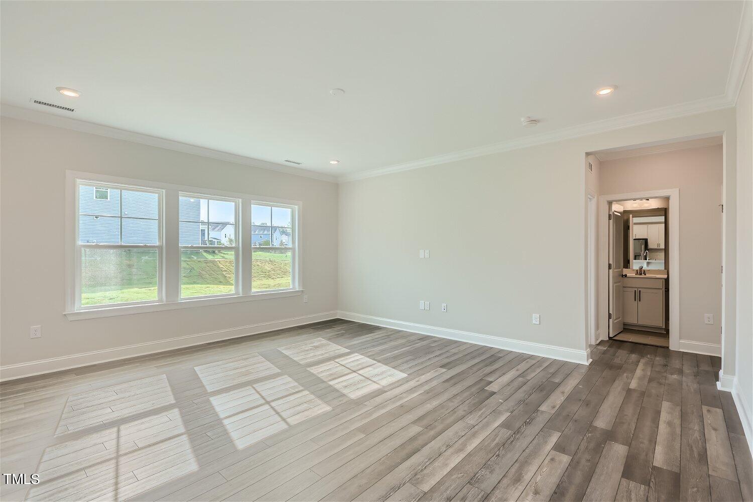 544 Tanner Lake Lane, Unit 294 Raleigh, NC 27610 - Photo 4 of 16 wooden floor in an empty room with a window