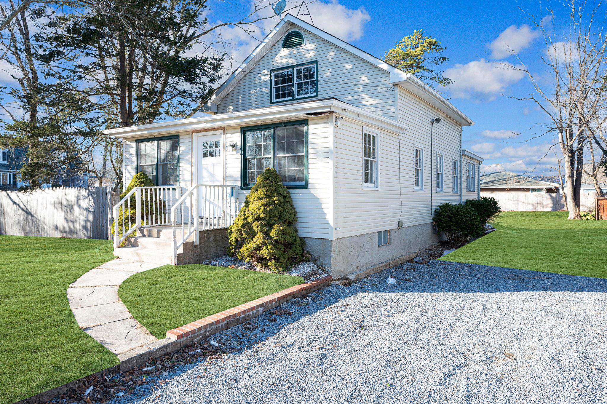 49 Cedar Road East Mastic Beach, NY 11951 - Photo 1 of 1 View of front of home with a front lawn