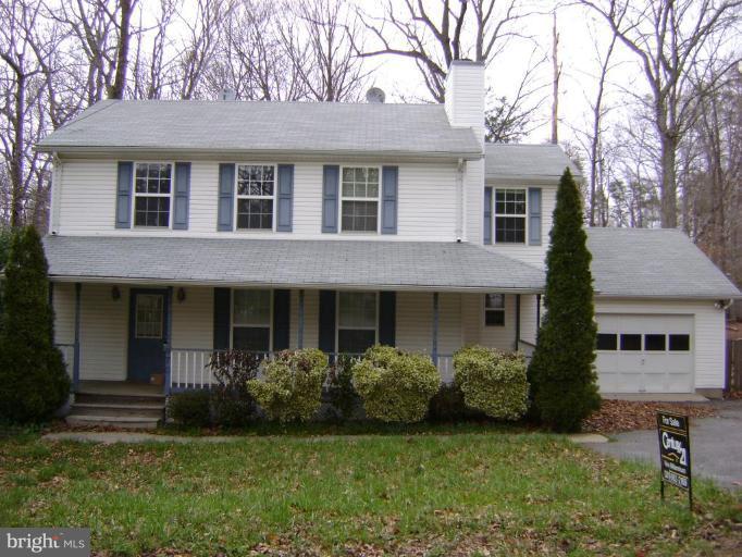 670 San Gabriel Road Lusby, MD 20657 - Photo 1 of 10 a view of a house with a yard plants and large tree