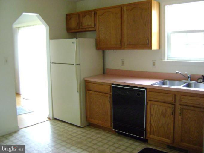670 San Gabriel Road Lusby, MD 20657 - Photo 3 of 10 a kitchen with a refrigerator and cabinets