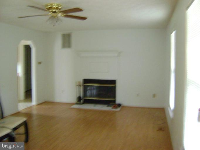 670 San Gabriel Road Lusby, MD 20657 - Photo 4 of 10 a living room with a stove and a refrigerator