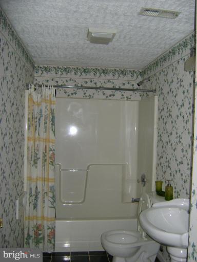 670 San Gabriel Road Lusby, MD 20657 - Photo 8 of 10 a bathroom with a toilet and a shower