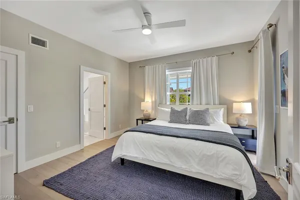 a bathroom with a toilet a sink a mirror and vanity