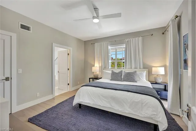 a bathroom with a toilet a sink a mirror and vanity