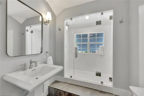 a room with a bed and a chandelier