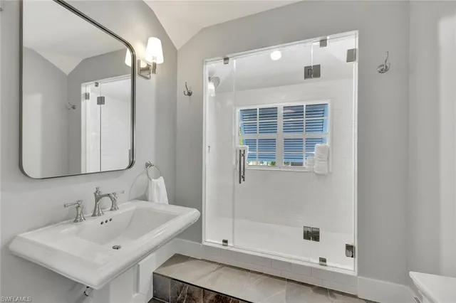 a room with a bed and a chandelier