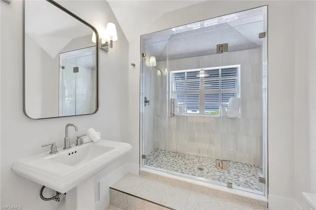 a bedroom with a bed and a lamp