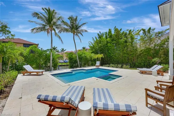 a front view of building with yard swimming pool and outdoor seating