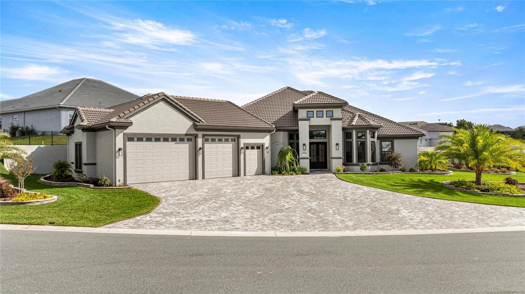 a front view of a house with a garden and yard