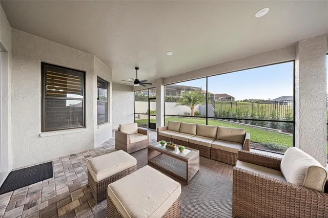 a view of a swimming pool with outdoor seating