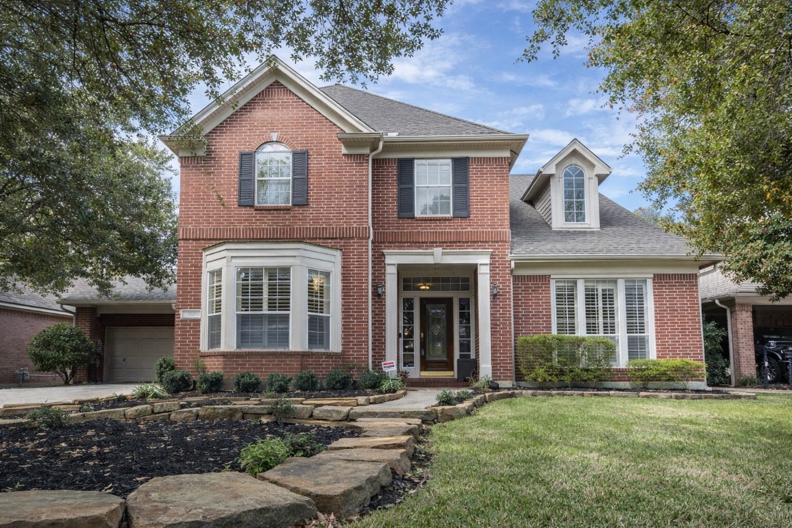 Discover your dream home at 5718 Oakmoss Trail—a charming brick facade nestled amidst serene greenery.