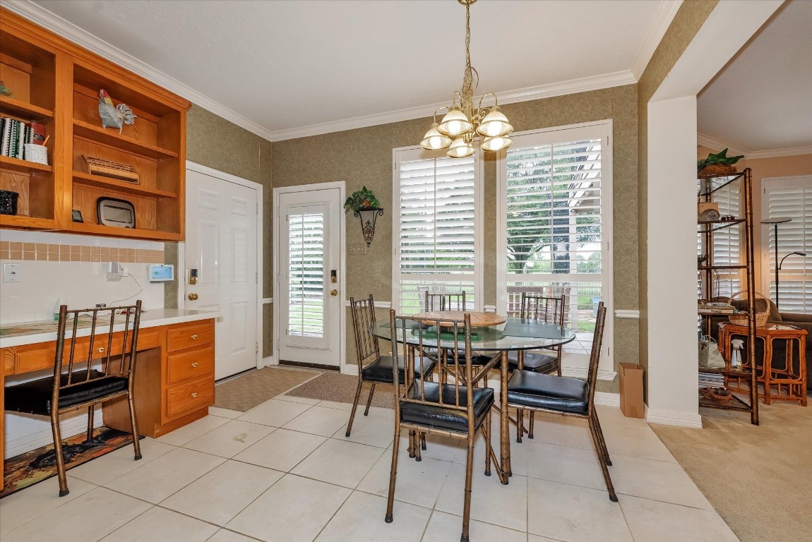 5718 Oakmoss Trail Spring, TX 77379 - Photo 17 of 50 Bright dining area with serene backyard views, seamlessly connected to the kitchen for effortless living.