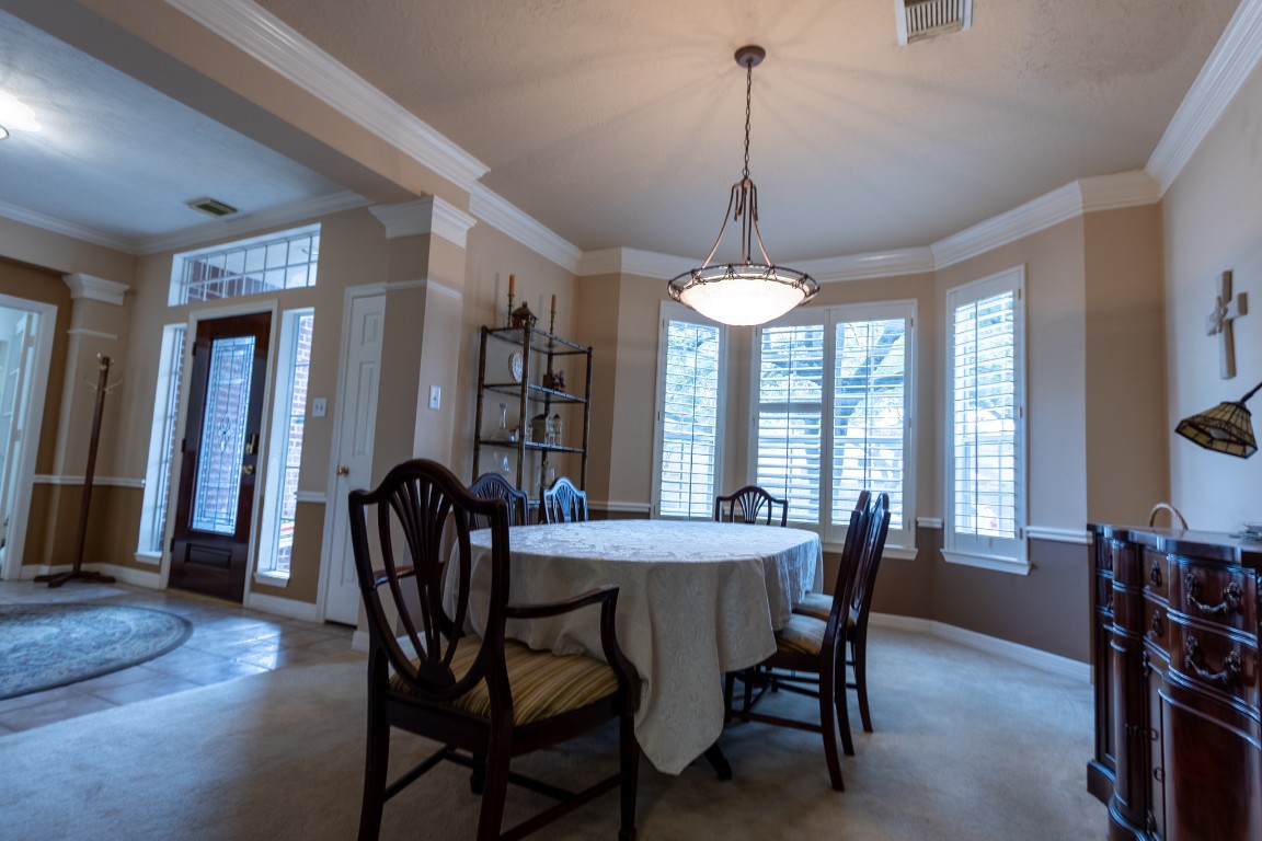 5718 Oakmoss Trail Spring, TX 77379 - Photo 19 of 50 Elegant dining room with stunning custom plantation shutters.