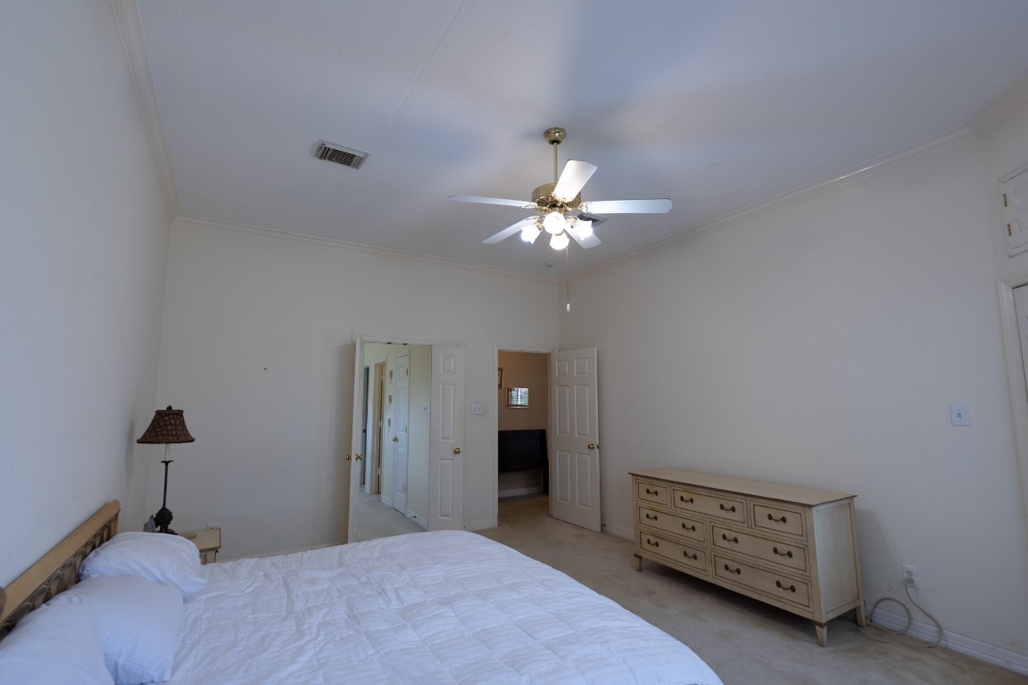 5718 Oakmoss Trail Spring, TX 77379 - Photo 26 of 50 Elevate your living experience in this expansive first-floor primary suite, elegantly framed with crown molding.