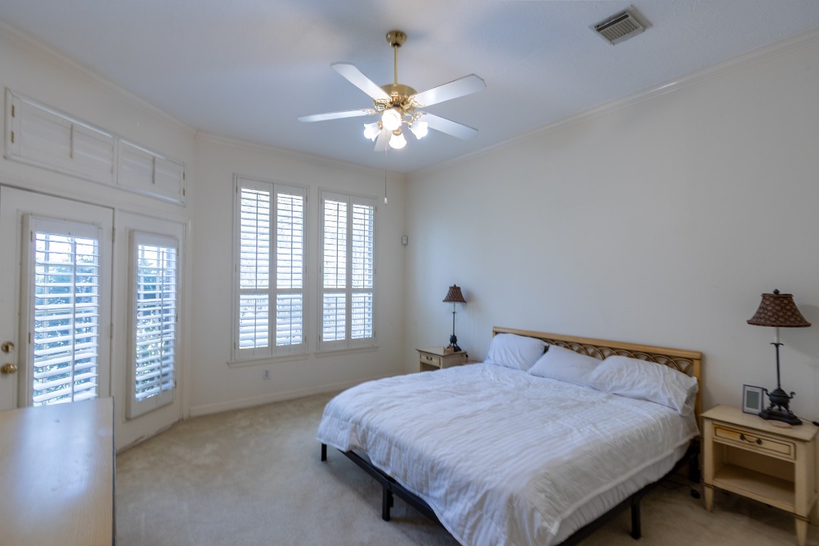 5718 Oakmoss Trail Spring, TX 77379 - Photo 27 of 50 Spacious primary suite with soaring ceilings and tranquil backyard views — your private retreat.