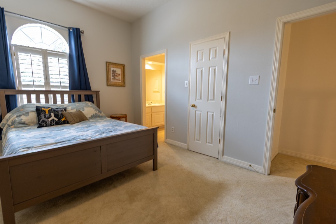 5718 Oakmoss Trail Spring, TX 77379 - Photo 41 of 50 Cozy third bedroom featuring an Jack-n-Jill bathroom and ample natural light, perfect for guests or a home office.