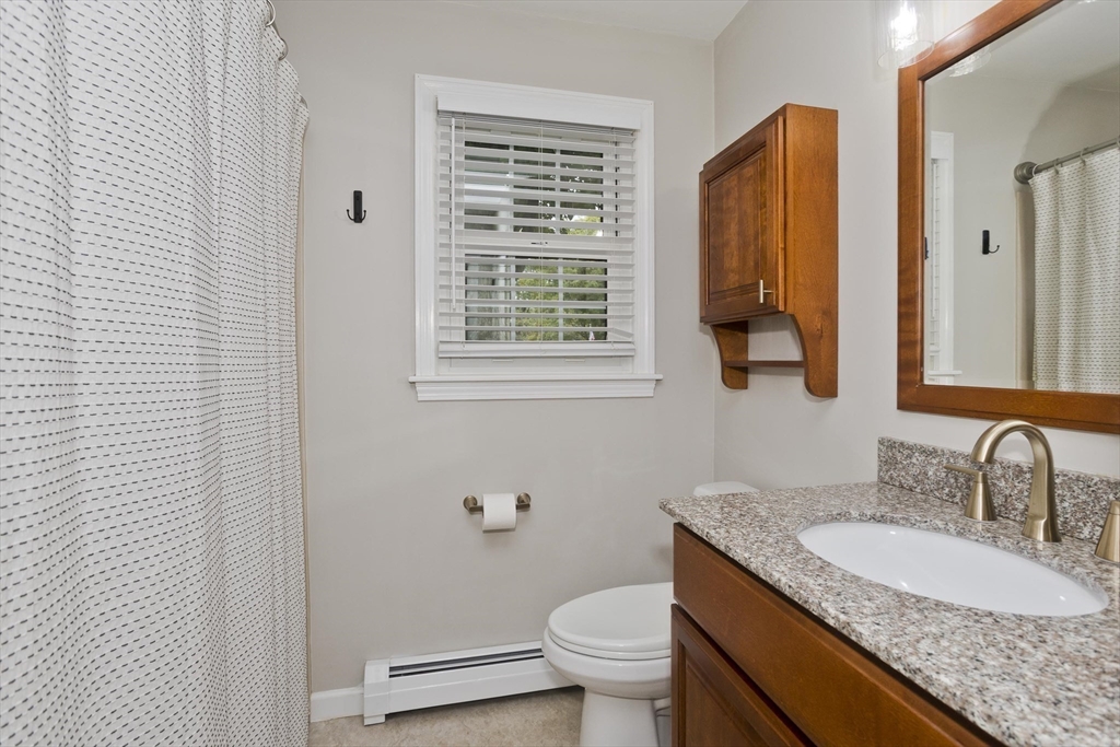 213 Spring Grove Avenue Northampton, MA 01062 - Photo 23 of 41 a bathroom with a granite countertop sink and a mirror