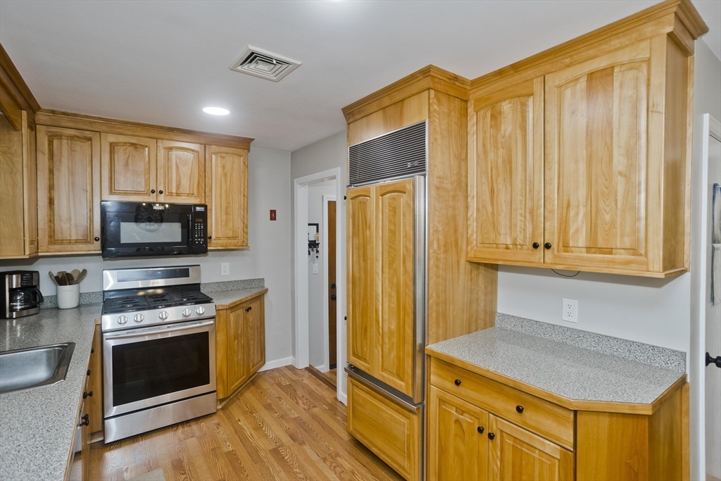 213 Spring Grove Avenue Northampton, MA 01062 - Photo 9 of 41 a kitchen with stainless steel appliances a stove a microwave and a refrigerator