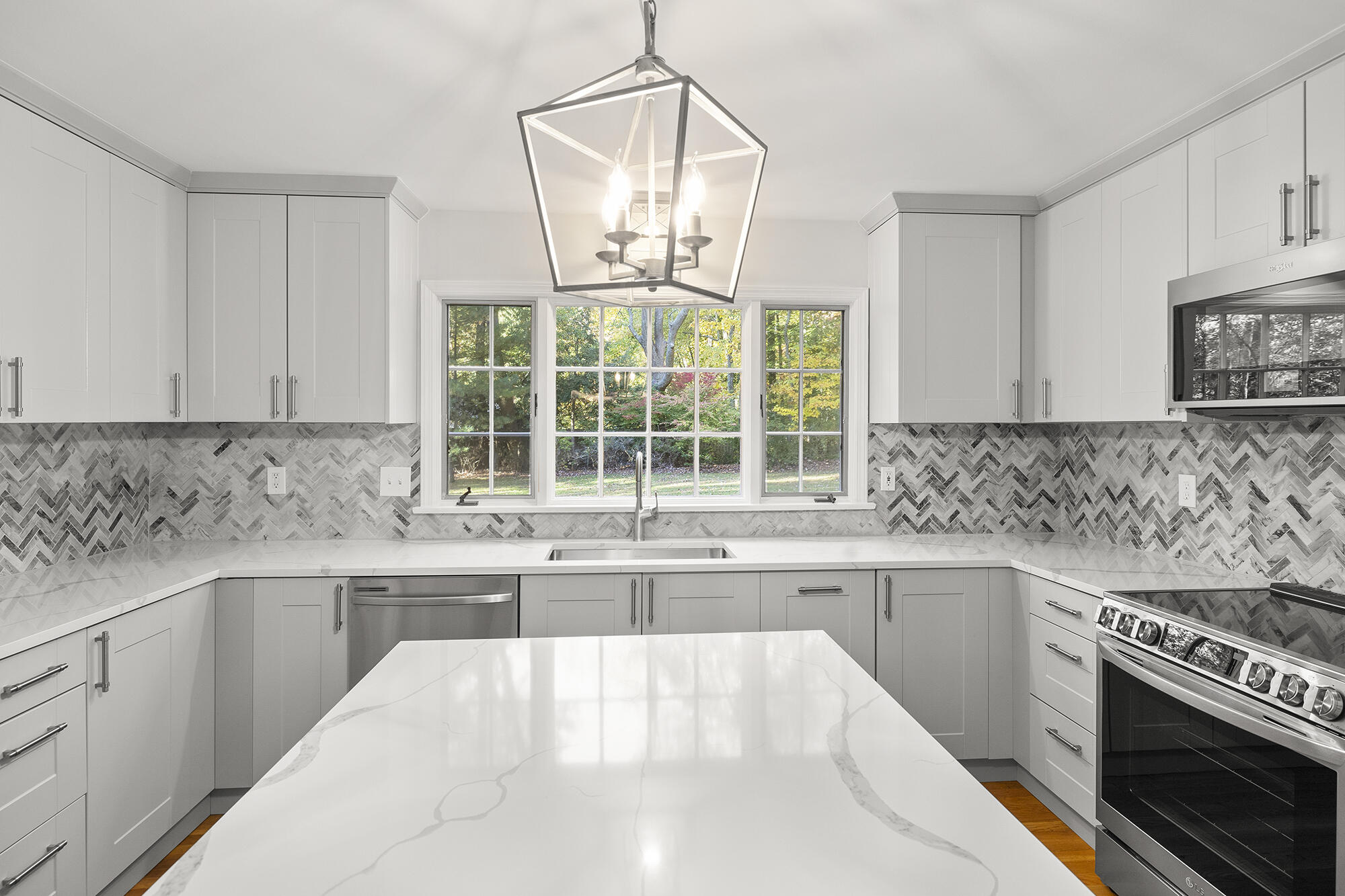10 Pilgrim Road Darien, CT 06820 - Photo 11 of 31 a kitchen with a sink stove and cabinets