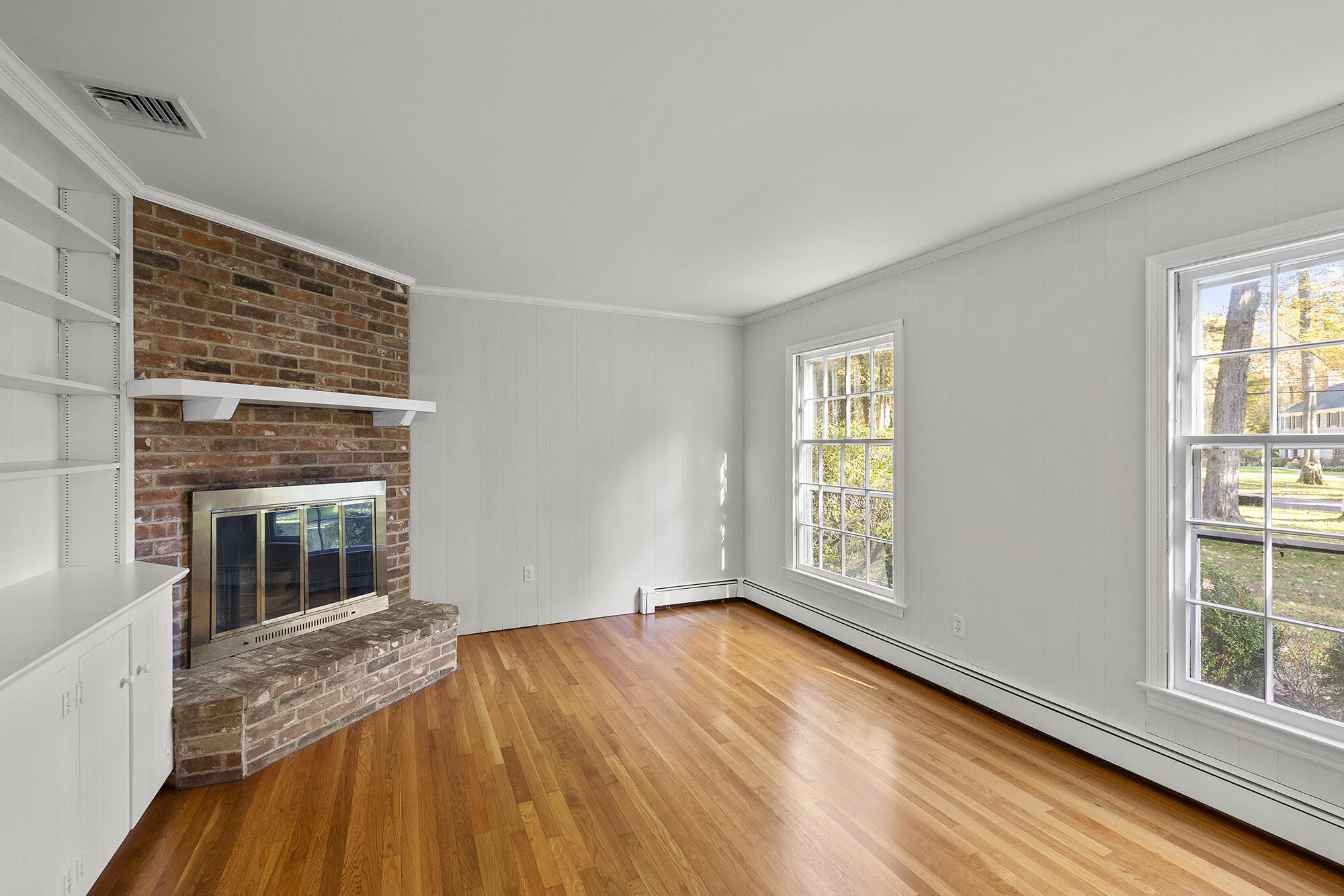 10 Pilgrim Road Darien, CT 06820 - Photo 18 of 31 a view of an empty room with wooden floor and a window