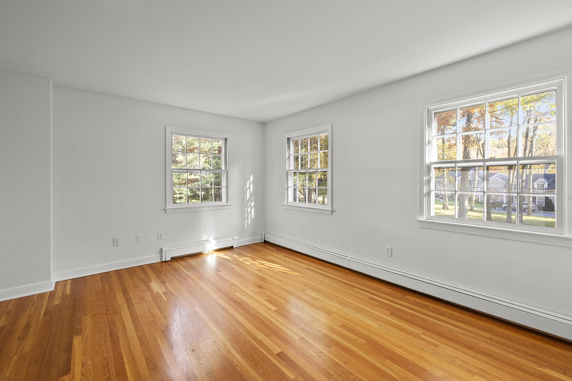 10 Pilgrim Road Darien, CT 06820 - Photo 20 of 31 a view of an empty room with a window and wooden floor