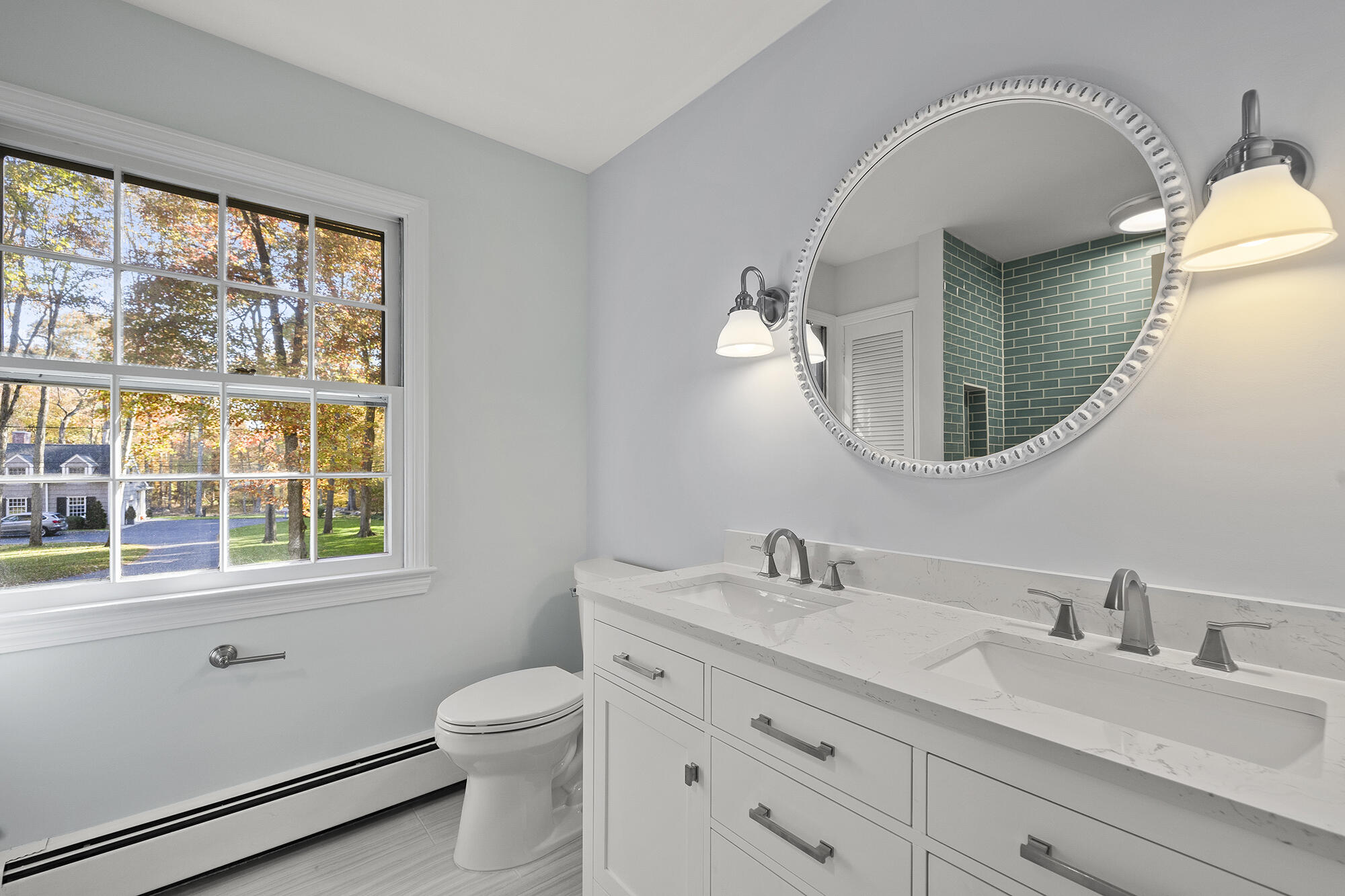 10 Pilgrim Road Darien, CT 06820 - Photo 23 of 31 a bathroom with a toilet a sink a mirror a window and vanity