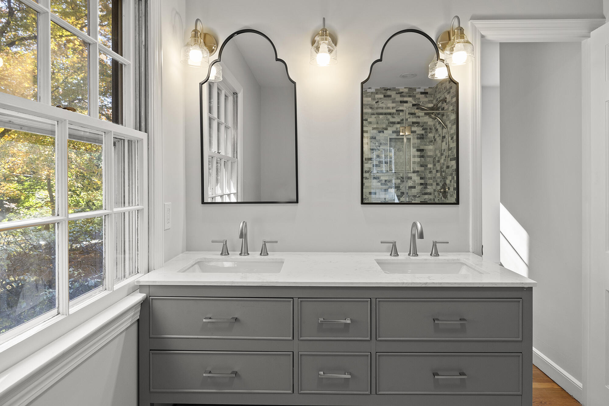 10 Pilgrim Road Darien, CT 06820 - Photo 27 of 31 a bathroom with double vanity sink two mirror and windows