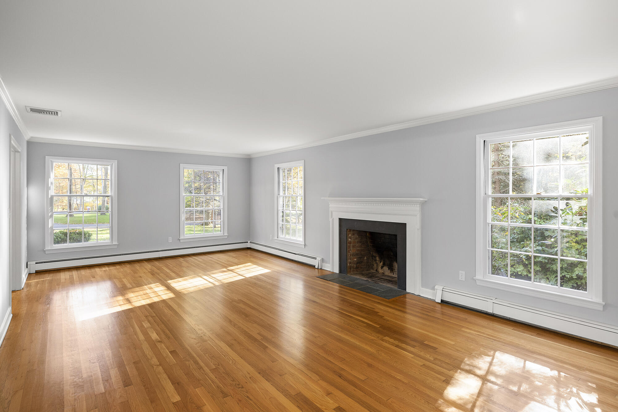10 Pilgrim Road Darien, CT 06820 - Photo 6 of 31 wooden floor fireplace and windows in an empty room
