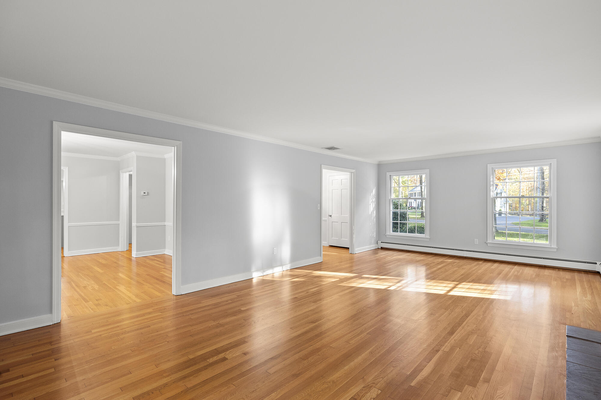 10 Pilgrim Road Darien, CT 06820 - Photo 7 of 31 a view of an empty room with wooden floor and a window