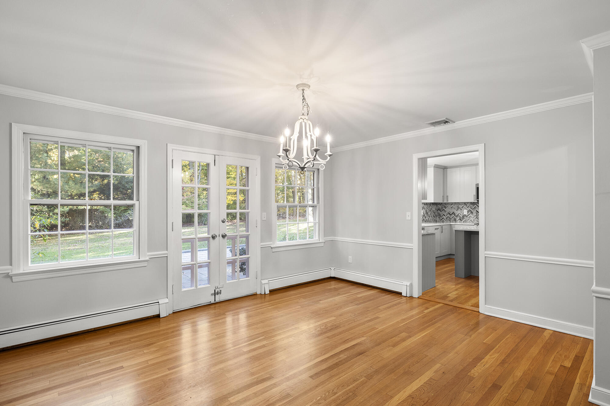 10 Pilgrim Road Darien, CT 06820 - Photo 8 of 31 an empty room with wooden floor and windows