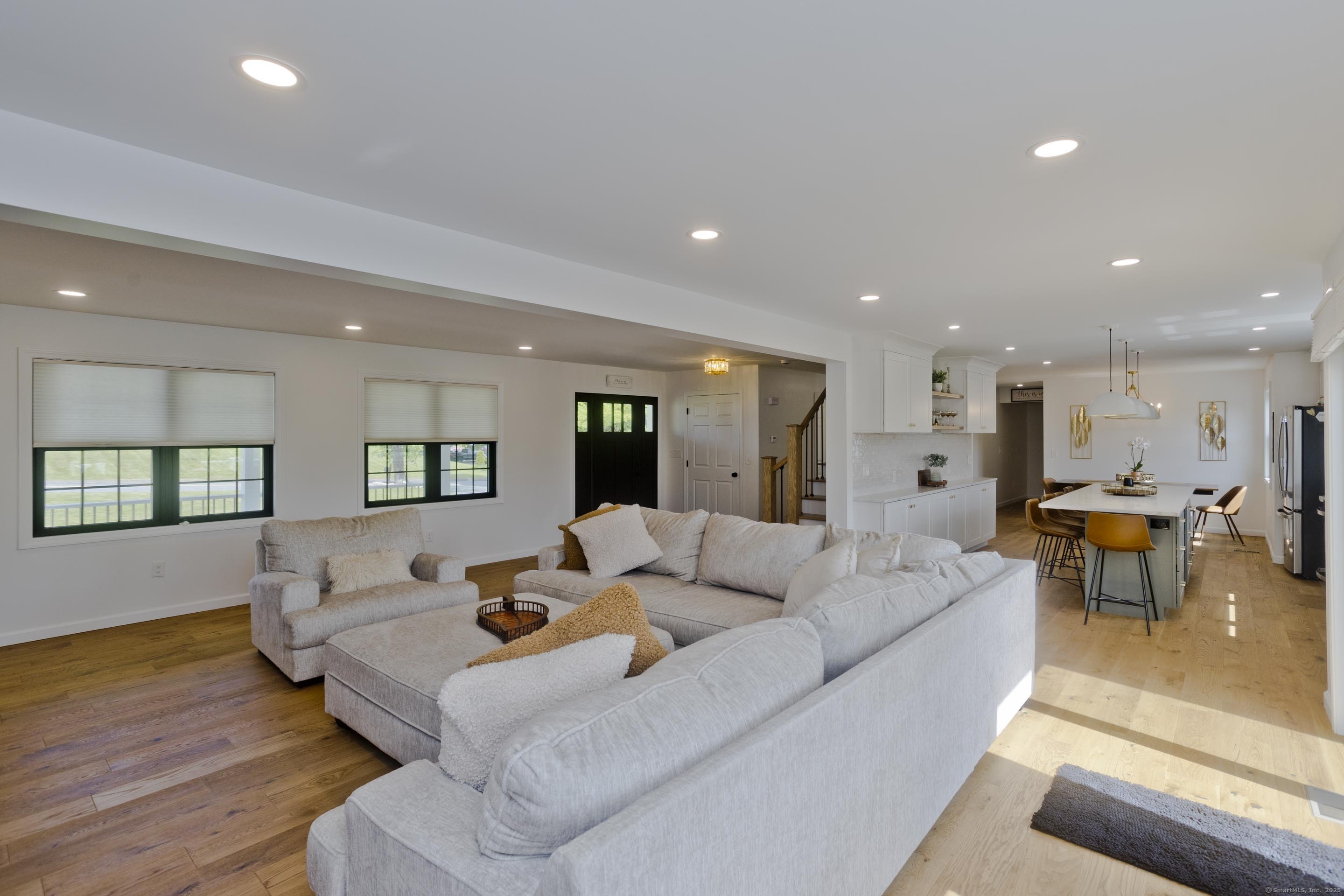 56 Margaret Street Monson, MA 01057 - Photo 15 of 39 a living room with furniture and a dining table with kitchen view