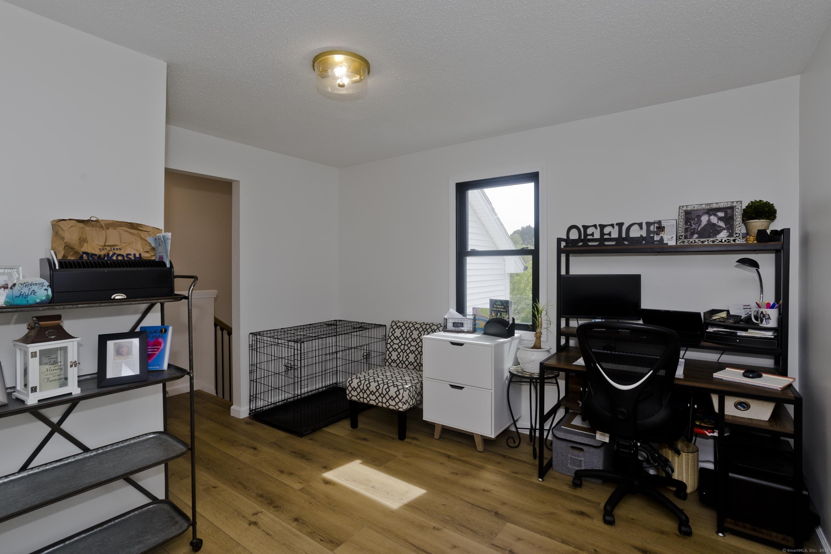 56 Margaret Street Monson, MA 01057 - Photo 24 of 39 a bedroom with a bed and a tv on the table