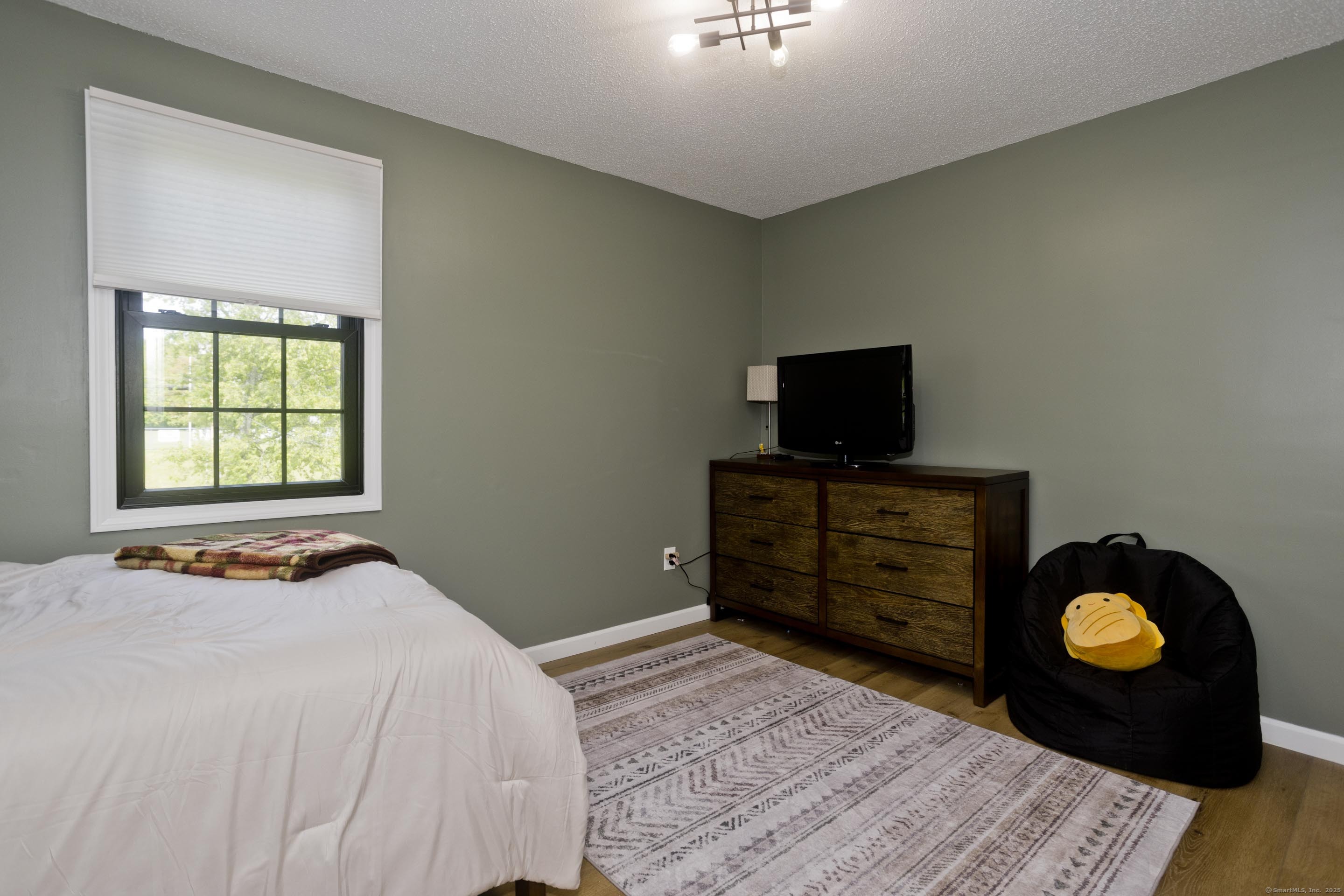 56 Margaret Street Monson, MA 01057 - Photo 25 of 39 a bedroom with a bed and flat screen tv