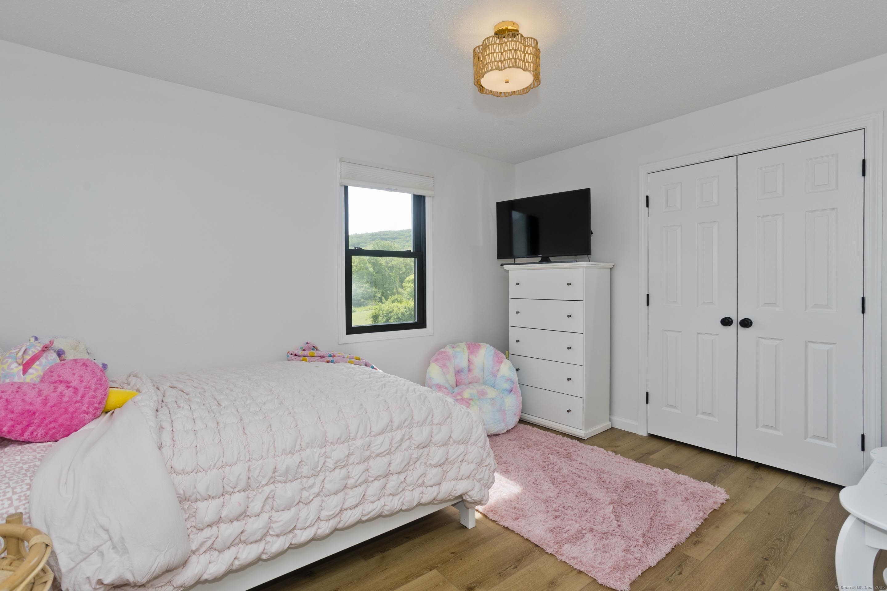 56 Margaret Street Monson, MA 01057 - Photo 27 of 39 a bedroom with a bed and a flat screen tv