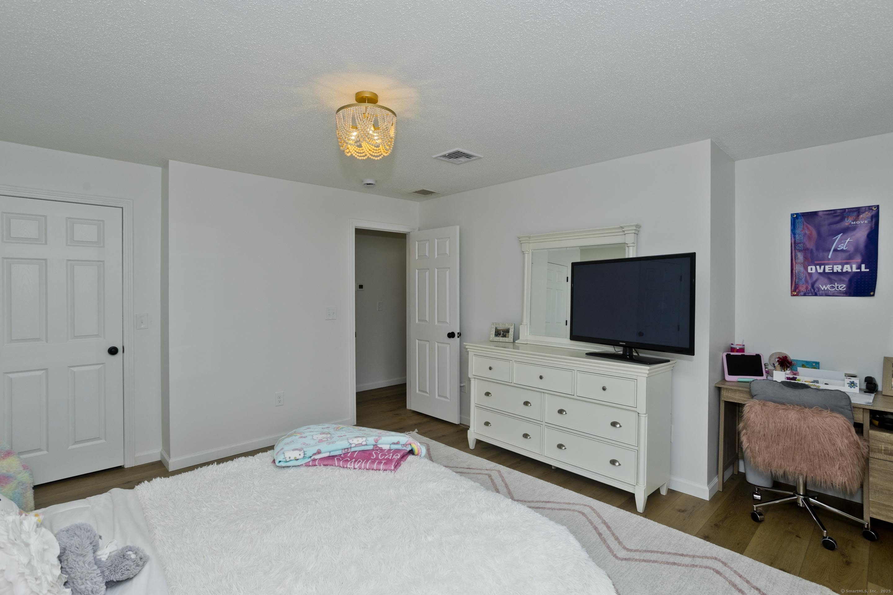 56 Margaret Street Monson, MA 01057 - Photo 30 of 39 a bedroom with a bed and wooden floor