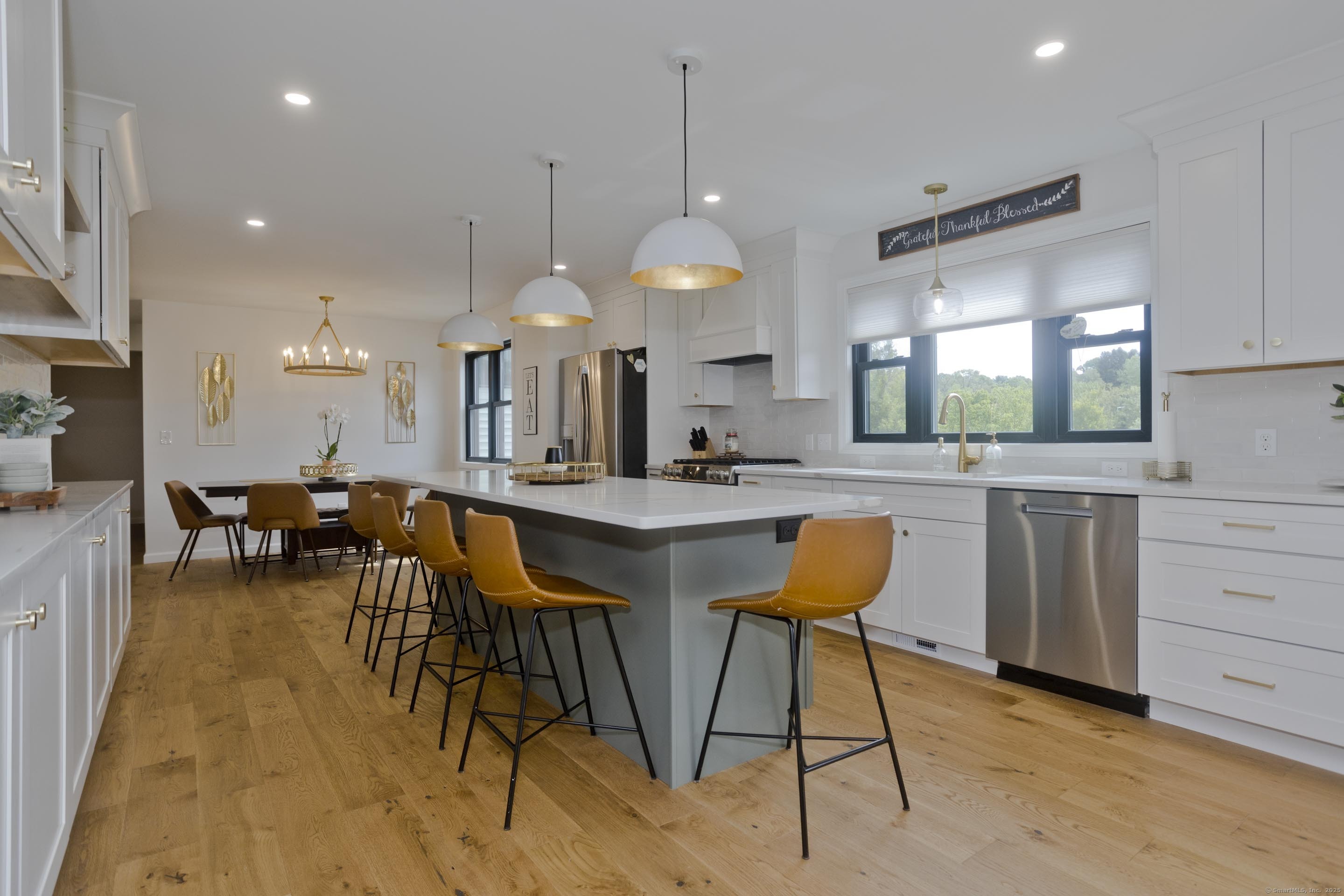 56 Margaret Street Monson, MA 01057 - Photo 6 of 39 a kitchen with stainless steel appliances kitchen island granite countertop a table chairs sink and cabinets