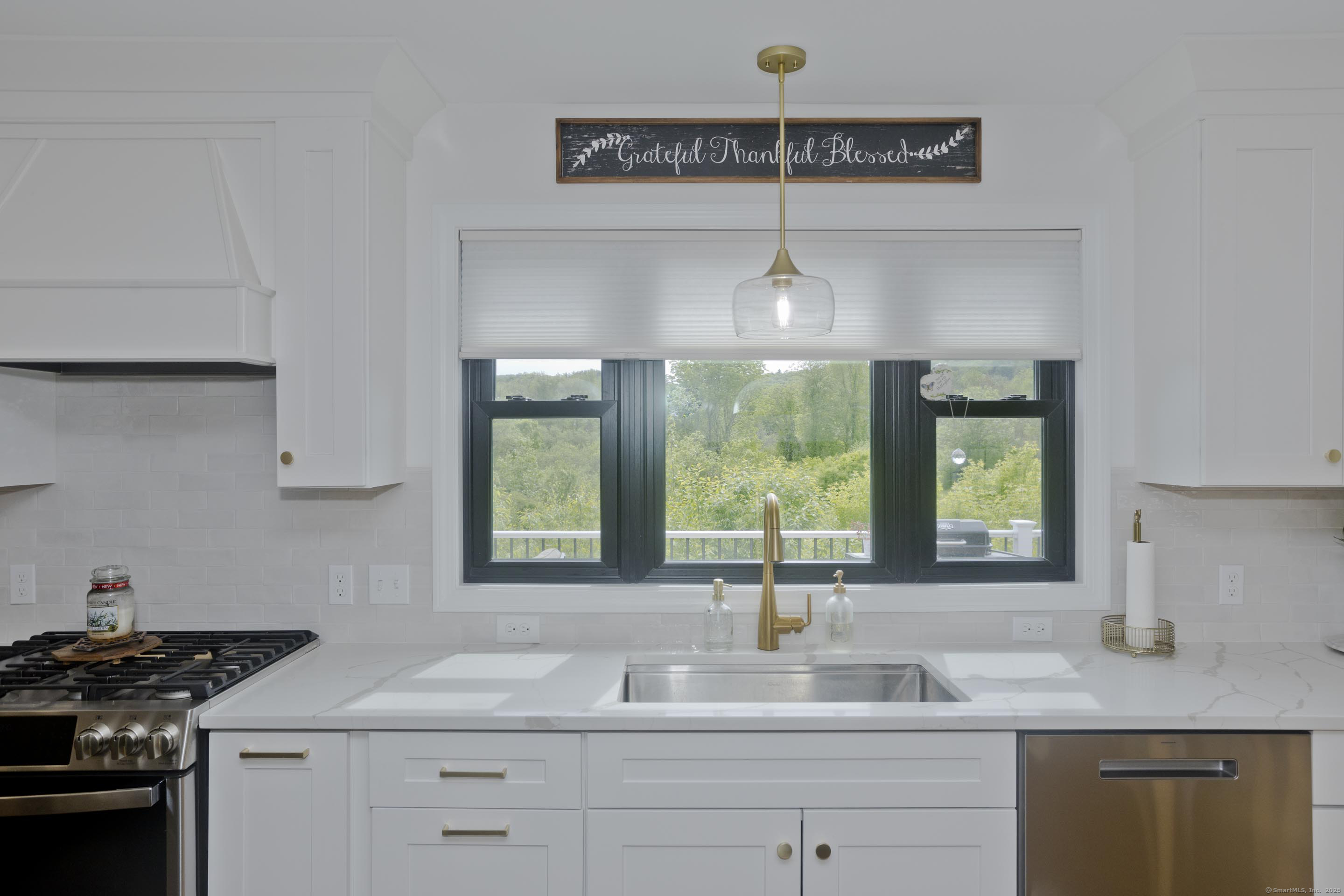 56 Margaret Street Monson, MA 01057 - Photo 7 of 39 a kitchen with stainless steel appliances granite countertop a sink a stove and a granite counter tops with white cabinets