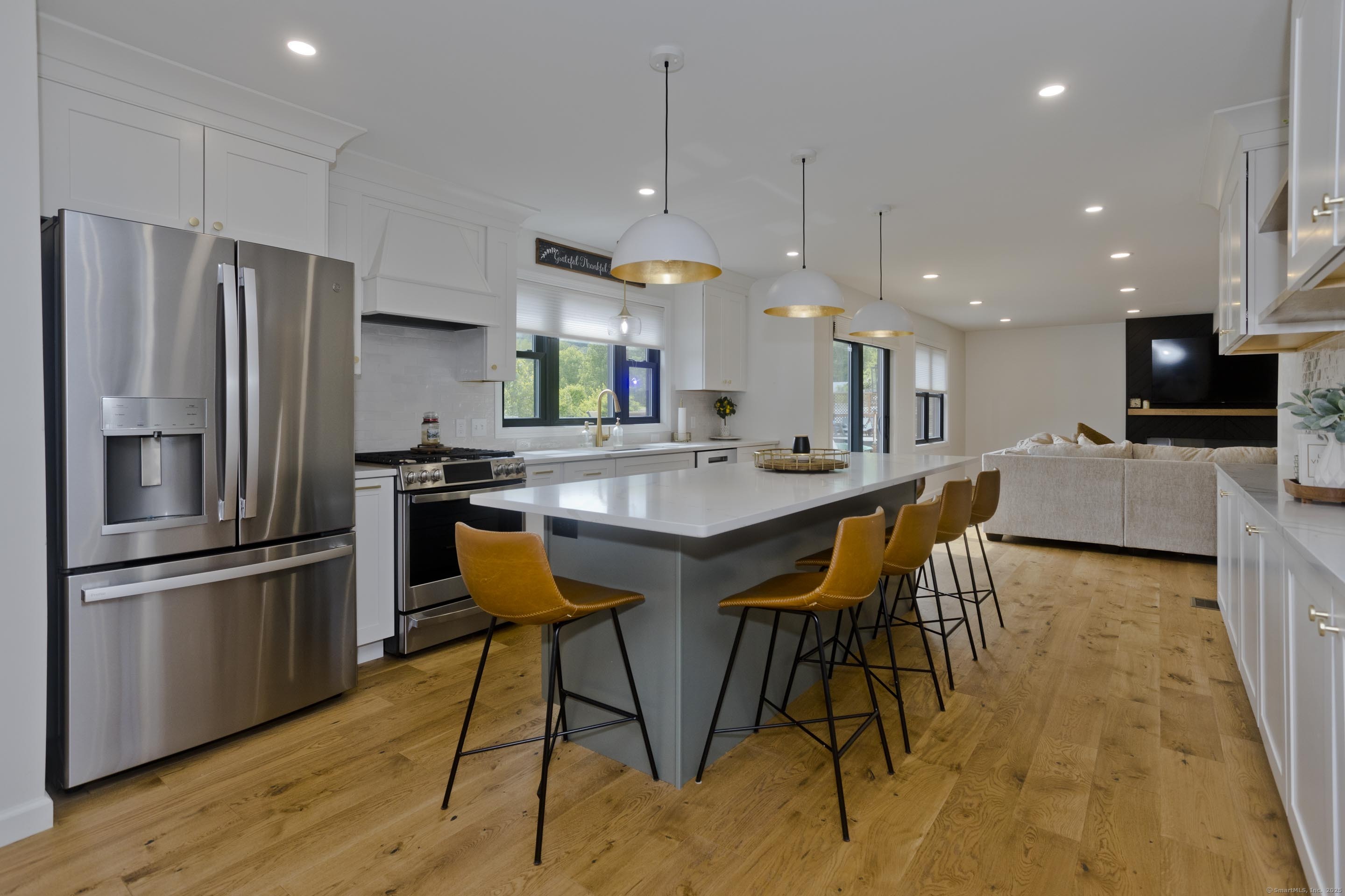 56 Margaret Street Monson, MA 01057 - Photo 10 of 39 a kitchen with stainless steel appliances kitchen island granite countertop a dining table chairs sink refrigerator and microwave