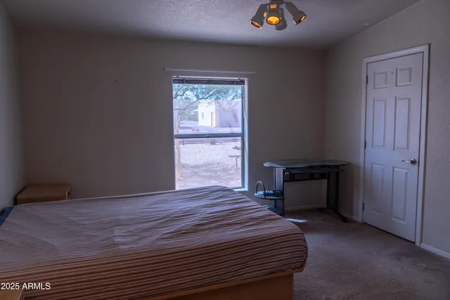 a bedroom with a bed and a chandelier