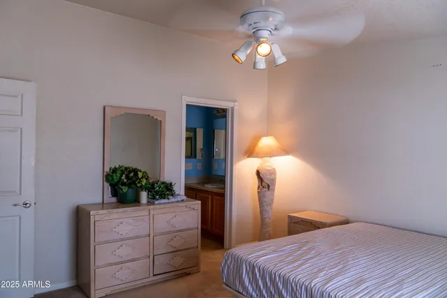 a bedroom with a bed and a potted plant