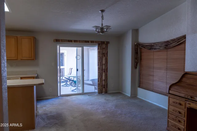 a view of an empty room with a fireplace and a window