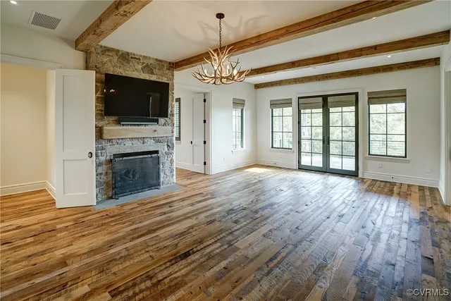 a view of a livingroom with an empty space and a fireplace