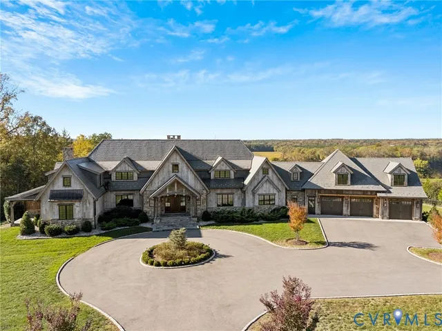 an aerial view of a house with swimming pool and porch